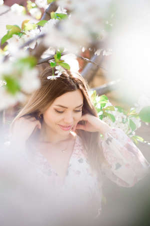 A beautiful girl in a blooming spring garden.