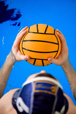 Water polo training. Young sportsman plays water polo in the pool.の写真素材
