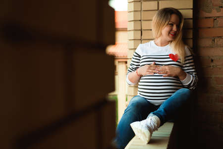Young preganant woman expecting a baby relaxingの写真素材