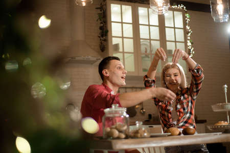 The newlyweds prepare dinner in the evening and play with flour.の写真素材