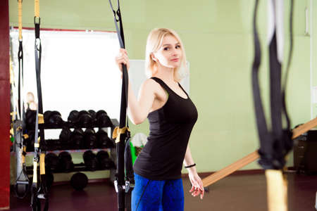 Portrait of beautiful young fit woman during traning in the gym.
