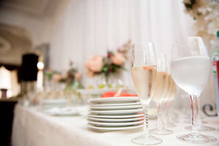 Wine glasses with a cool delicious champagne or white wine at the bar. Alcohol background.の写真素材