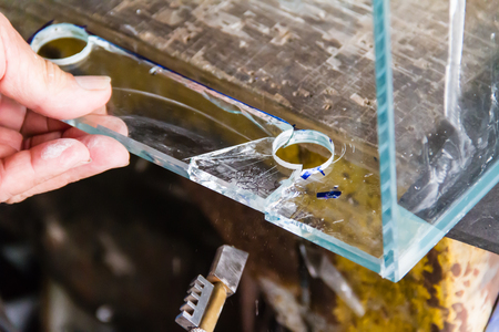 Cutting glass in square pattern after drilledの写真素材