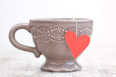 cup with heart shaped tea bagの写真素材
