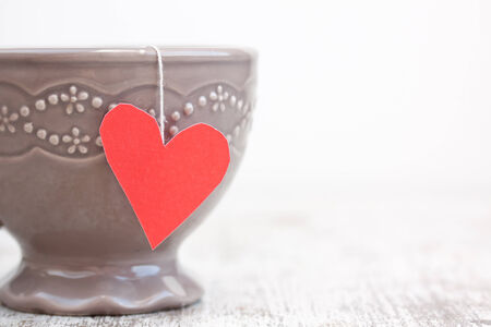 cup with heart shaped tea bagの写真素材