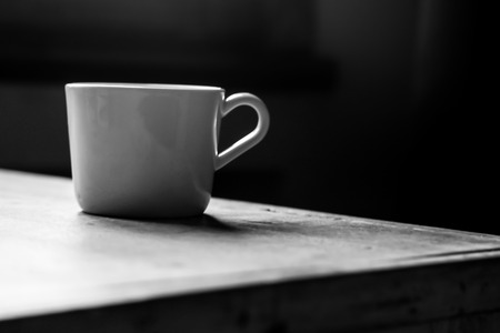 white mug on a wooden tableの写真素材