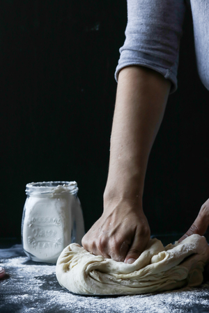 Kneading dough with flourの写真素材