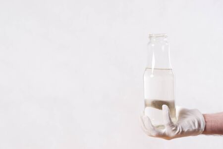 hand in gloves with bottle of water.の写真素材