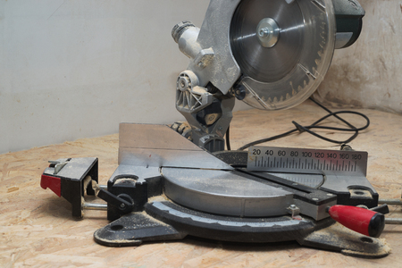 Carpenter tools on wooden table with sawdust. Circular Saw. Copy space.の写真素材