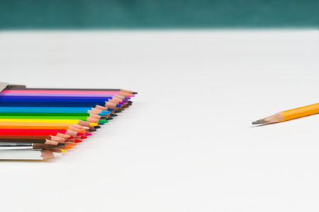 Multicolored pensils in the box on the white paper.の写真素材