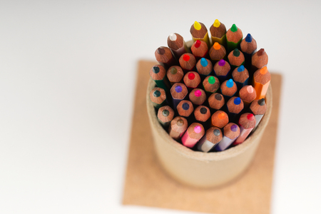 Multicolored pensils in the box on the white paper.の写真素材