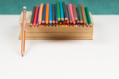 Multicolored pensils on the book. Back to school. Copy space.の写真素材