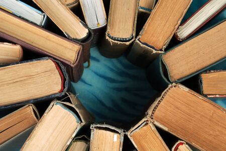 Stack of hardback books on wooden table. Back to school. Copy space.の写真素材