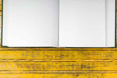 Open book on wooden table. Back to school. Copy space. Top view.