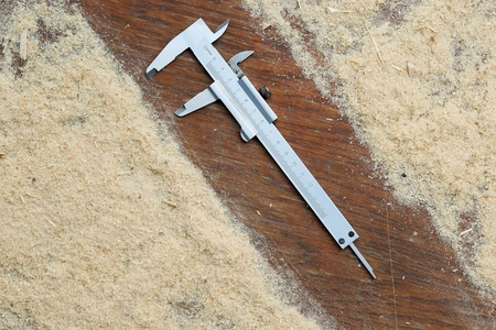 Carpenter tools on wooden table with sawdust.の写真素材