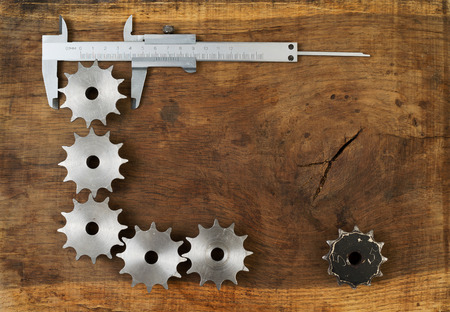 Engineering tools gears and caliper on wooden table. Success concept.の写真素材