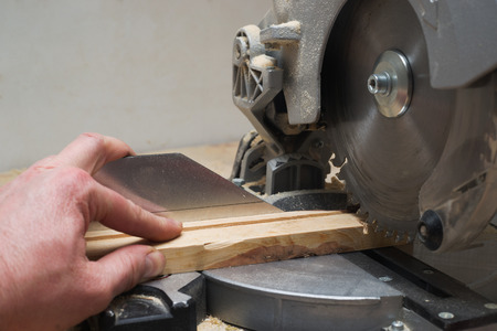 Carpenter tools on wooden table with sawdust. Circular Saw. Copy space.