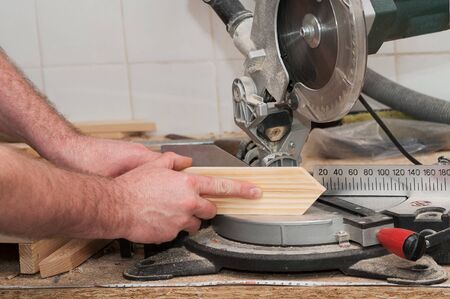 Carpenter tools on wooden table with sawdust. Circular Saw. Cutting a wooden plank.の写真素材