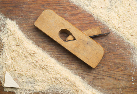 Carpenter tools on wooden table with sawdust. Carpenter workplace top view