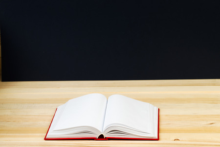 Open book, stack of hardback book on wooden table. Back to school. Copy space. Top view.の写真素材