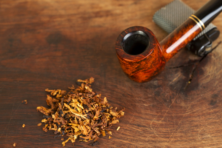 Smoking pipe on a wooden table. Aroma. Copy space. Top view.の写真素材