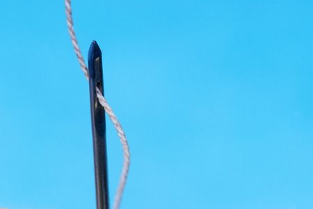 Leather craft tools on a wooden background. Leather craftmans work desk . Piece of hide and working handmade tools on a work table.の写真素材