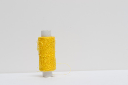 Sewing textile or cloth. Work table of a tailor. Textile tools. Reel of thread and natural fabric.の写真素材