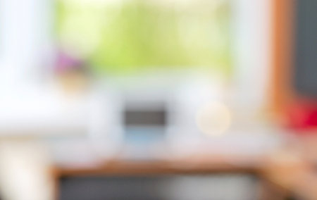 Abstract office desk table with computer, supplies, flower blur background. Copy space for text.の写真素材