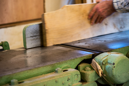 Carpenter tools on wooden table with sawdust. Circular Saw. Cutting a wooden plankの写真素材