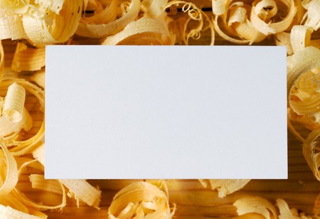 Business card on wooden table for carpenter tools with sawdust.の写真素材