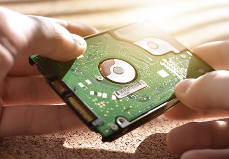 Engineering design holds the hard drive. Repair of computer equipment. Memory. Repair shop. Solar flare.の写真素材