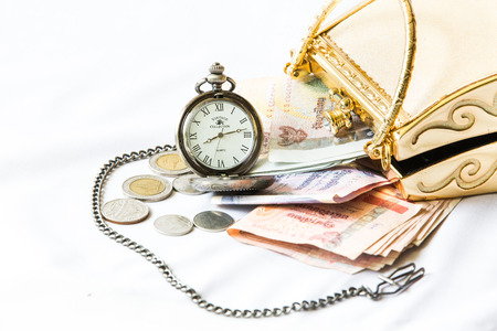 Golden clutch ,money and  vintage pocket watch ,Time and financial concept.の写真素材