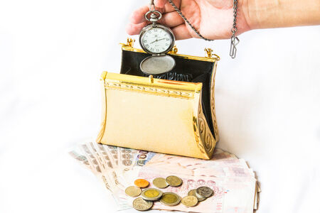Golden clutch ,money and  vintage pocket watch ,Time and financial concept.の写真素材