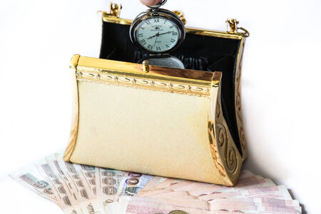 Golden clutch ,money and  vintage pocket watch ,Time and financial concept.の写真素材