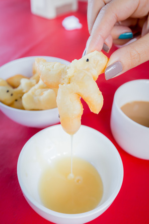 Deep-fried dough stick Chinese flour sweetmeat with Sweetened Condensed Milk.の写真素材