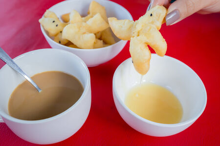 Deep-fried dough stick Chinese flour sweetmeat with Sweetened Condensed Milk.の写真素材