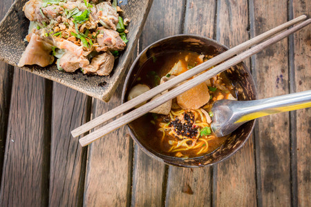 Pork noodle spicy soup in coconut Bowl,Thai noodle.の写真素材