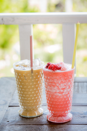 Ice coffee and Strawberry Smoothie on wood table.の写真素材