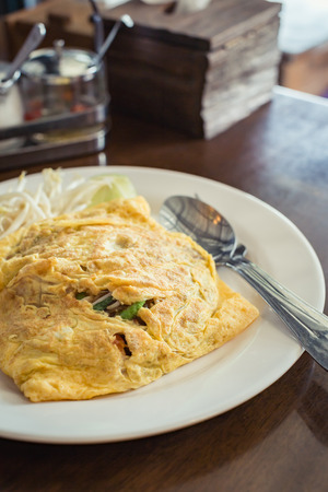 Fried noodle Thai style with egg omelet, Fried Noodles in Egg Wrap.の写真素材