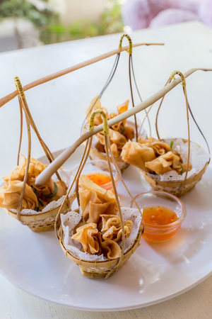 Deep fried Chinese sheet wrap minced pork by shallot with sweet sauce call gold bag in Thai.Thai appetizersの写真素材