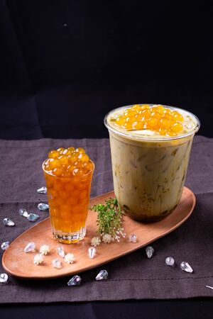 Taiwan milk tea,bubble tea in plastic cups on a wooden plate.の写真素材