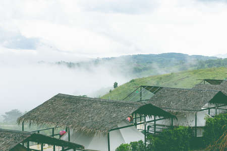 High voltage transmission towers on mountain with fog.in thailandの写真素材