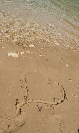 a heart sign in the beach sandの写真素材