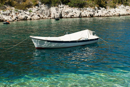 Small white boat on the scenic seaの写真素材