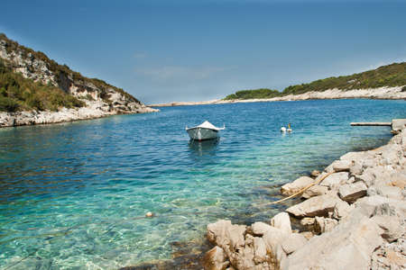 Small white boat on the scenic seaの写真素材