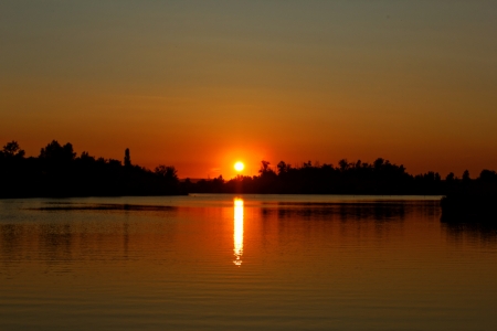 Colorful sunset over tranquil water surface.の写真素材