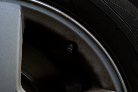 close up tire valve on the rim of a luxury sports car の写真素材