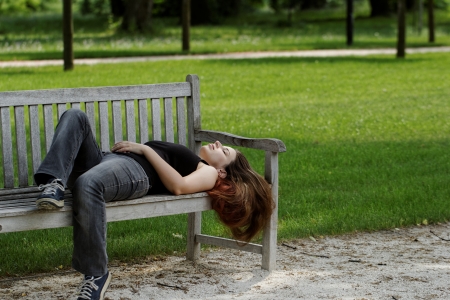 pretty young girl couch on a benchの写真素材