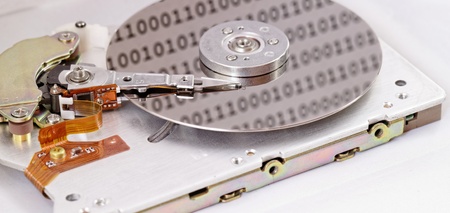 Internals of a computer harddrive with binary number reflections (HDD, winchester)の写真素材