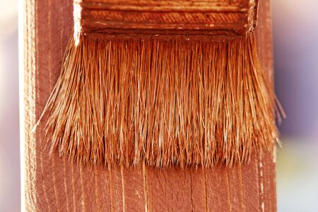 planks fence dyeing with brown paint and brushの写真素材